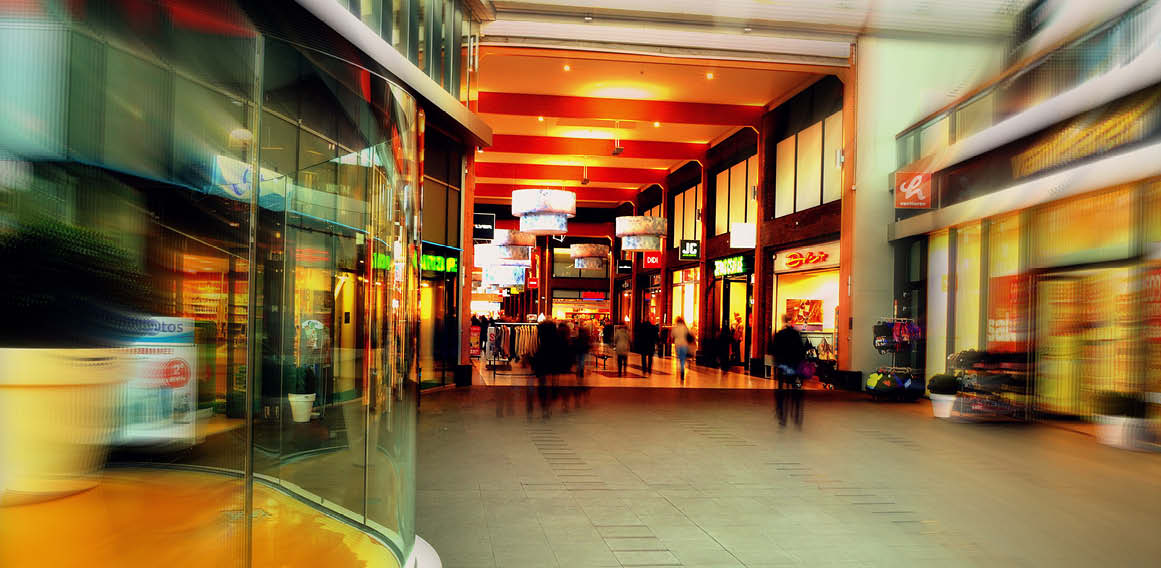 Centro comercial con tiendas híbridas y compradores en lugar físico