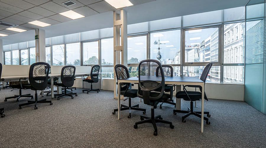 Espacio de trabajo con puestos operativos y mesas de reuniones