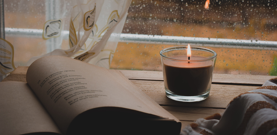 Solida_EDIT6_Pexels_Teletrabajo vela y libro en casa con ventana con lluvia espacio acogedor