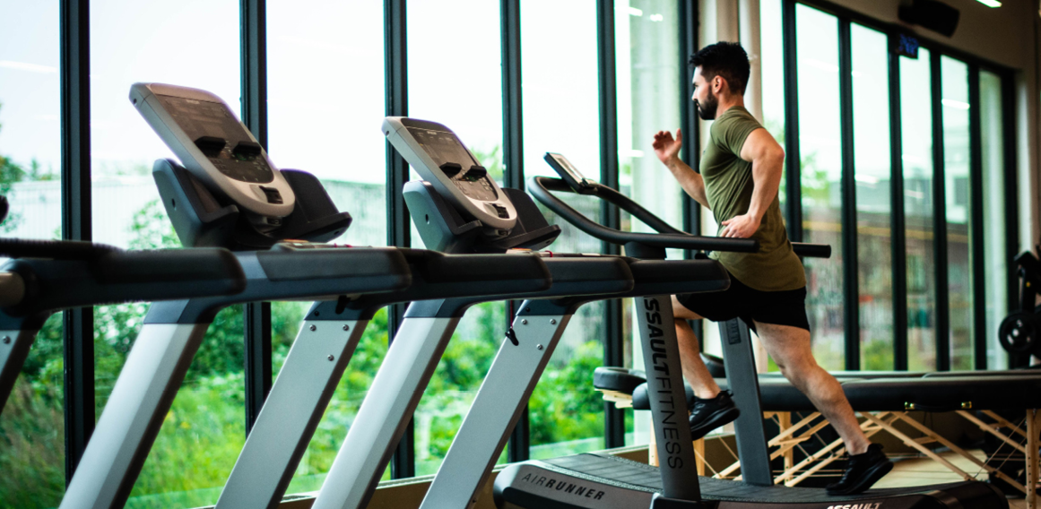 persona entrenando en el gimnasio máquinas de correr